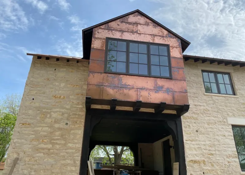 Copper metal panel facade on a stone building for Skylight Installation in Brigham City