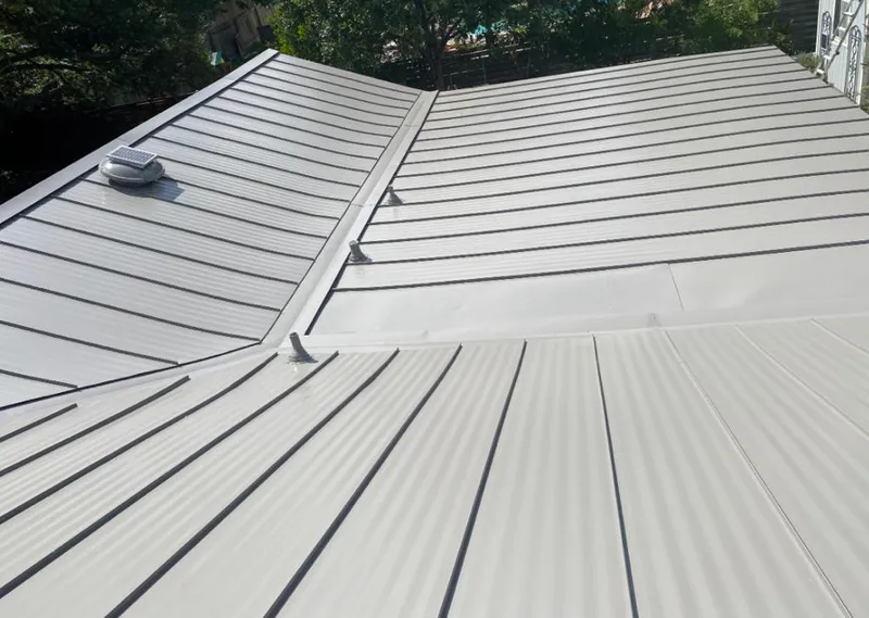 Solar attic fan installed on a metal roof for Roof Ventilation in Brigham City